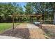Outdoor space featuring a wooden pergola structure, ideal for gatherings or relaxing outdoors at 7722 Nc 27, Lillington, NC 27546
