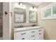 Bathroom featuring a double vanity with modern fixtures and framed mirrors at 7722 Nc 27, Lillington, NC 27546