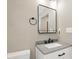 Modern bathroom with a sleek vanity, stylish mirror, and neutral color palette creating a serene space at 7722 Nc 27, Lillington, NC 27546