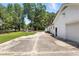 Long driveway leading to a garage and a pergola, offering privacy and additional space for outdoor activities at 7722 Nc 27, Lillington, NC 27546
