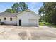 Exterior view of the white brick garage with a single door, offering convenient parking and storage options at 7722 Nc 27, Lillington, NC 27546