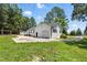 Exterior shot showcasing a white brick garage with a driveway, providing ample parking and storage at 7722 Nc 27, Lillington, NC 27546