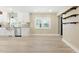 Open concept kitchen area featuring modern appliances, wood floors and a large window at 7722 Nc 27, Lillington, NC 27546