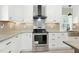 Modern kitchen with stainless steel appliances, white cabinets, granite countertops and tile backsplash at 7722 Nc 27, Lillington, NC 27546