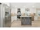 Bright, renovated kitchen with stainless steel appliances, a center island, and white cabinetry at 7722 Nc 27, Lillington, NC 27546