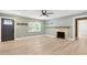 Inviting living room with a rustic fireplace and large windows that bring in lots of natural light at 7722 Nc 27, Lillington, NC 27546