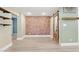 Stylish living room showcases a brick accent wall and floating wood shelves at 7722 Nc 27, Lillington, NC 27546