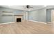 Open-concept living area with recessed lighting, ceiling fan, and a cozy fireplace at 7722 Nc 27, Lillington, NC 27546