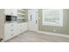 Stylish mudroom featuring shaker cabinets, granite counters, and natural lighting from the window at 7722 Nc 27, Lillington, NC 27546