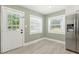 Mud room area featuring shaker cabinets, granite counters, and an exterior entrance at 7722 Nc 27, Lillington, NC 27546