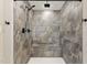 Shower featuring stone-look tile and a built in bench at 7722 Nc 27, Lillington, NC 27546