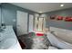 Spacious bathroom features a shower, soaker tub, and and sinks at 8836 Thornton Garden Ln, Raleigh, NC 27616