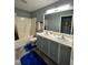 Bright bathroom featuring dual sinks, mirror, and tub at 8836 Thornton Garden Ln, Raleigh, NC 27616