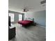 Bright bedroom with wood-look floors, ceiling fan, and lots of natural light at 8836 Thornton Garden Ln, Raleigh, NC 27616