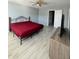 Spacious bedroom featuring wood-look floors, ceiling fan, and natural light at 8836 Thornton Garden Ln, Raleigh, NC 27616