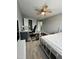 Bedroom with laminate floors, ceiling fan, and adjacent office/study space at 8836 Thornton Garden Ln, Raleigh, NC 27616