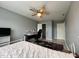 Cozy bedroom featuring ceiling fan, large rug, and desk area perfect for work or study at 8836 Thornton Garden Ln, Raleigh, NC 27616