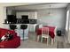Open dining area with table, chairs, and view of the kitchen with black appliances at 8836 Thornton Garden Ln, Raleigh, NC 27616
