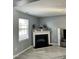Living room with a fireplace, decorations, light floors, and gray walls at 8836 Thornton Garden Ln, Raleigh, NC 27616