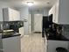Kitchen with black countertops, black appliances, backsplash and white cabinets at 8836 Thornton Garden Ln, Raleigh, NC 27616