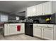 Bright kitchen with white cabinets, black countertops, and stainless steel appliances at 8836 Thornton Garden Ln, Raleigh, NC 27616