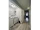 Bright laundry room with white washer, dryer, and wire shelving for convenient storage space at 8836 Thornton Garden Ln, Raleigh, NC 27616