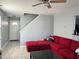 Cozy living room with a red sofa, wood ceiling fan, and light gray walls at 8836 Thornton Garden Ln, Raleigh, NC 27616