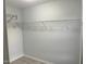 Empty walk-in closet featuring multiple shelves and rods for organization at 8836 Thornton Garden Ln, Raleigh, NC 27616