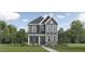 Charming two-story home featuring a stone-accented facade and a well-manicured lawn at 892 Cassa Clubhouse Way, Knightdale, NC 27545