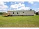 Spacious backyard featuring a wooden deck attached to the home at 100 Cottonwood Ct, Kenly, NC 27542