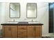 Bathroom featuring double vanity with framed mirrors and tiled shower with glass door at 100 Cottonwood Ct, Kenly, NC 27542