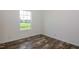 Empty bedroom with wood floor and a window with a backyard view at 100 Cottonwood Ct, Kenly, NC 27542