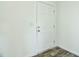 A solid white door featuring six panels, complemented by a light switch on the adjacent wall at 100 Cottonwood Ct, Kenly, NC 27542
