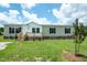 Charming manufactured home with a well-maintained lawn and inviting front porch at 100 Cottonwood Ct, Kenly, NC 27542