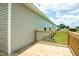 Exterior of the house with beige siding and a wooden porch with wooden railings at 100 Cottonwood Ct, Kenly, NC 27542
