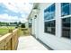 View of the covered front porch with railing and new windows overlooking the community at 100 Cottonwood Ct, Kenly, NC 27542