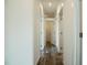 Hallway with hardwood floors, neutral paint, recessed lighting, and white doors at 100 Cottonwood Ct, Kenly, NC 27542