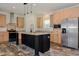 Spacious kitchen with stainless steel appliances, an island, wooden cabinets, and hardwood floors at 100 Cottonwood Ct, Kenly, NC 27542