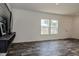 Living room with a mounted TV, hardwood floors, white walls, and natural light at 100 Cottonwood Ct, Kenly, NC 27542