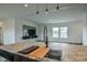 Open concept living area with tv, kitchen sink, and large windows at 100 Cottonwood Ct, Kenly, NC 27542