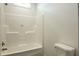 Bathroom with a white plastic shower and a white toilet at 100 Cottonwood Ct, Kenly, NC 27542
