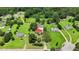 Aerial shot features a red-roofed home, surrounded by expansive green lawns and mature trees, and neighboring homesites at 1007 Windward Hill Ct, Middlesex, NC 27557