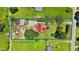 Aerial view of a homesite showcasing the approximate property boundaries, horse paddocks and red-roofed home at 1007 Windward Hill Ct, Middlesex, NC 27557