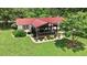 Elevated view of the home's red roof and welcoming front porch with professionally landscaped yard at 1007 Windward Hill Ct, Middlesex, NC 27557
