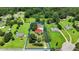 Aerial view of a homesite showing boundaries, a red-roofed home, mature trees and an expansive green lawn at 1007 Windward Hill Ct, Middlesex, NC 27557