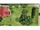 Expansive aerial view of a home showcasing a red roof and lush landscaping with mature trees at 1007 Windward Hill Ct, Middlesex, NC 27557