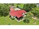 Aerial view showcasing a home with a red roof, screened porch, and beautifully landscaped yard at 1007 Windward Hill Ct, Middlesex, NC 27557