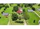 Aerial view of a home featuring a red roof, green lawn, mature trees and a long driveway at 1007 Windward Hill Ct, Middlesex, NC 27557