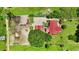 Aerial view shows a home with a red roof, and horse paddocks with extensive space for riding and recreation at 1007 Windward Hill Ct, Middlesex, NC 27557