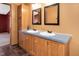 Bathroom with double sink vanity and wood cabinets, with a connecting room visible at 1007 Windward Hill Ct, Middlesex, NC 27557